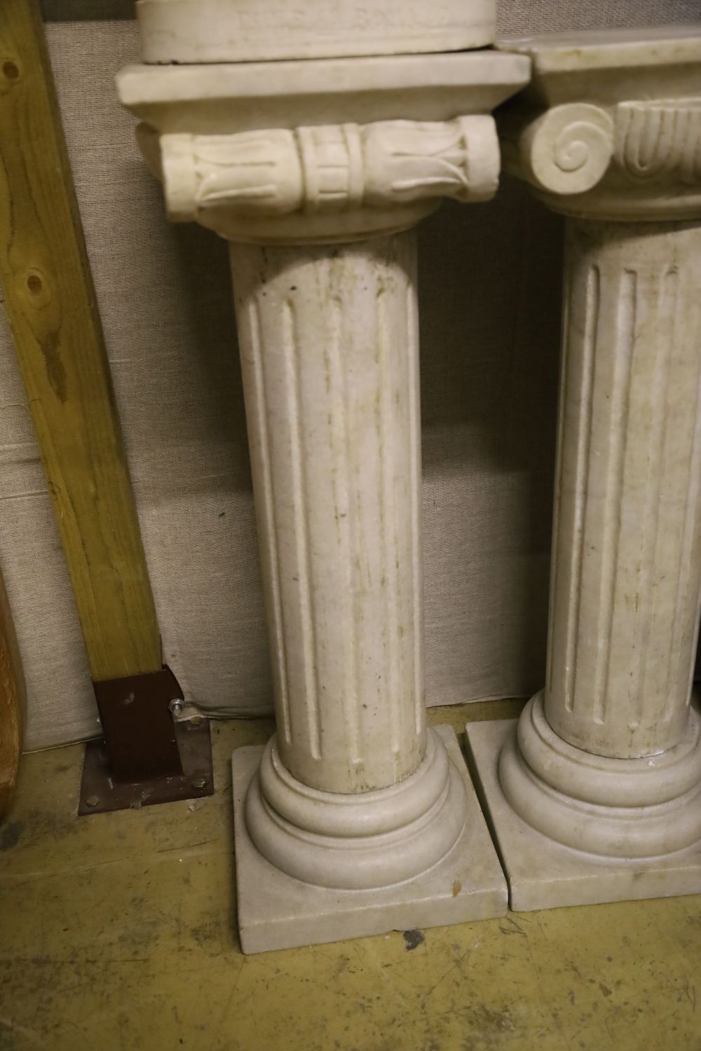 A pair of marble ionic columns together with a marble carving signed Esule, figure 70cm high